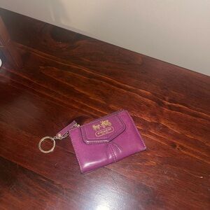 Coach coin purse in purple wallet